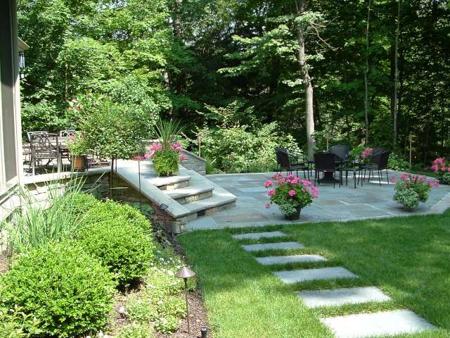 Walkway leading to patio and terrace designed by landscape architect.